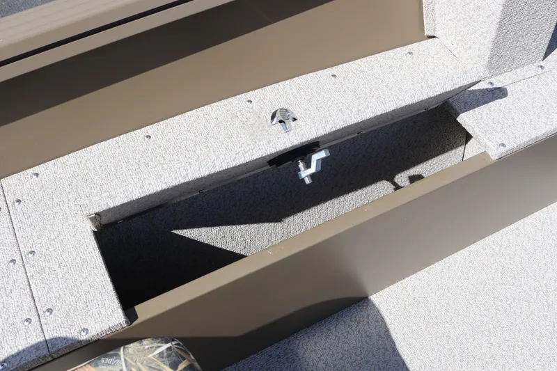 Slide: The Image of Storage compartment of 2026 Smoker Craft Freedom 160 TL boat, featuring durable carpeted interior. - 11