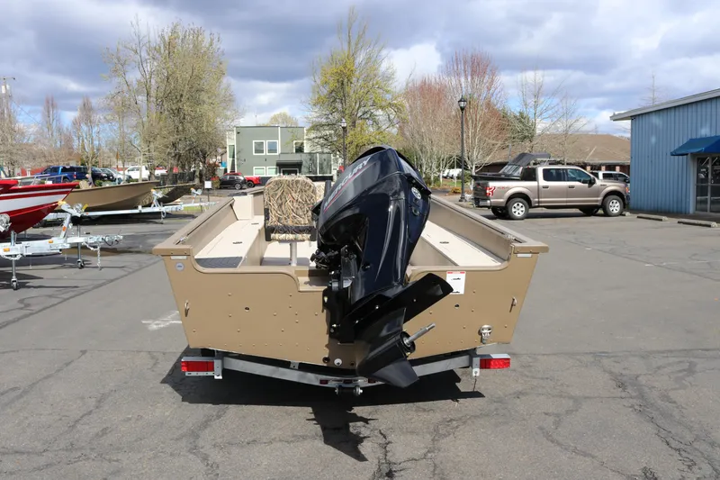 Slide: The Image of 2026 Smoker Craft Freedom 160 TL boat with outboard motor, parked outdoors. - 6