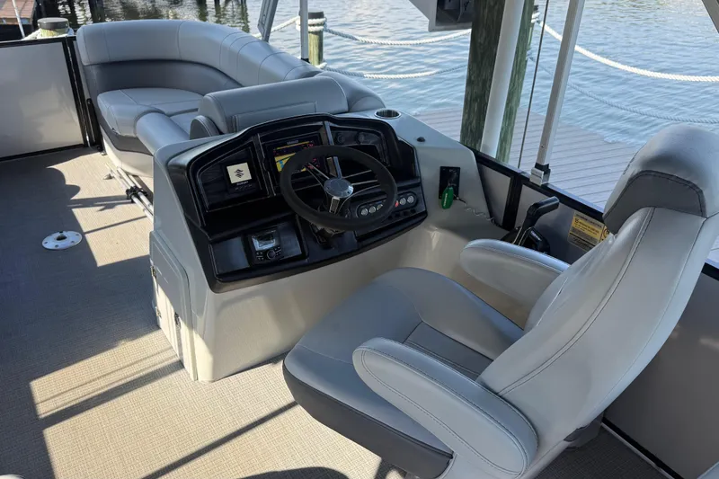 Slide: The Image of 2021 Bentley Pontoons 220/223 Elite Admiral helm with luxurious seating and controls. - 11