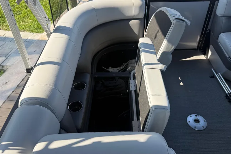 Slide: The Image of 2021 Bentley Pontoons 220/223 Elite Admiral interior with open storage and cup holders. - 12