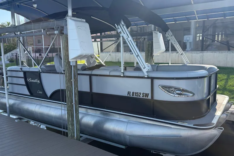 Slide: The Image of 2021 Bentley Pontoons 220/223 Elite Admiral docked under a canopy. - 4
