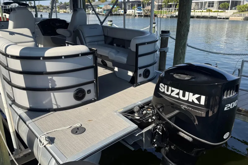 Slide: The Image of 2021 Bentley Pontoons 220/223 Elite Admiral with Suzuki 200 outboard motor docked. - 6