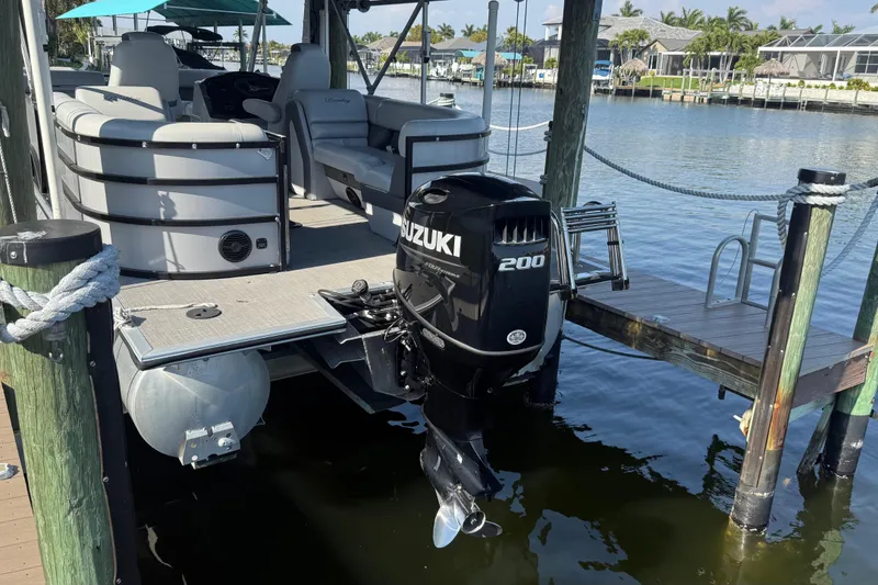 Slide: The Image of 2021 Bentley Pontoons 220/223 Elite Admiral with Suzuki 200 motor docked by waterfront. - 7