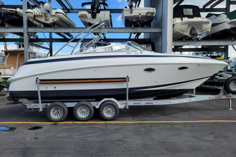 Slide: The Image of 2002 Cobalt 293 boat on a trailer in a marina storage facility. - 1
