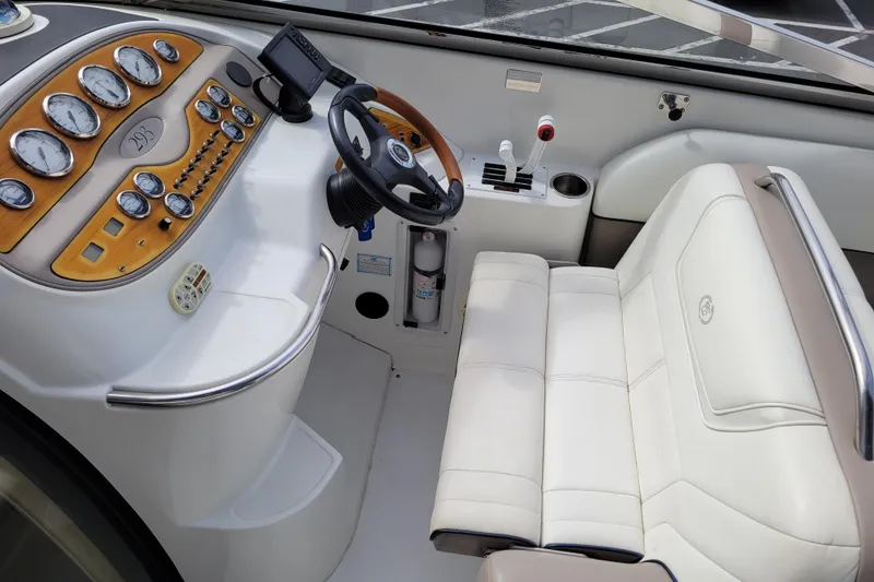 Slide: The Image of Interior of a 2002 Cobalt 293 boat cockpit with gauges and white seating. - 11