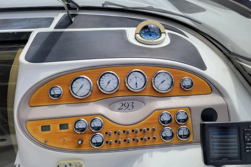 Slide: The Image of Dashboard of a 2002 Cobalt 293 boat with gauges and navigation equipment. - 12
