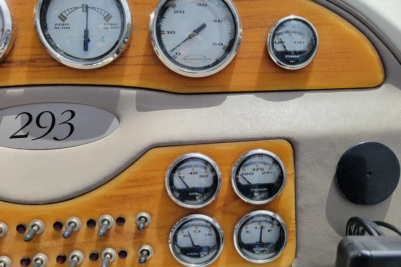 Slide: The Image of Dashboard of a 2002 Cobalt 293 boat with gauges and switches. - 16