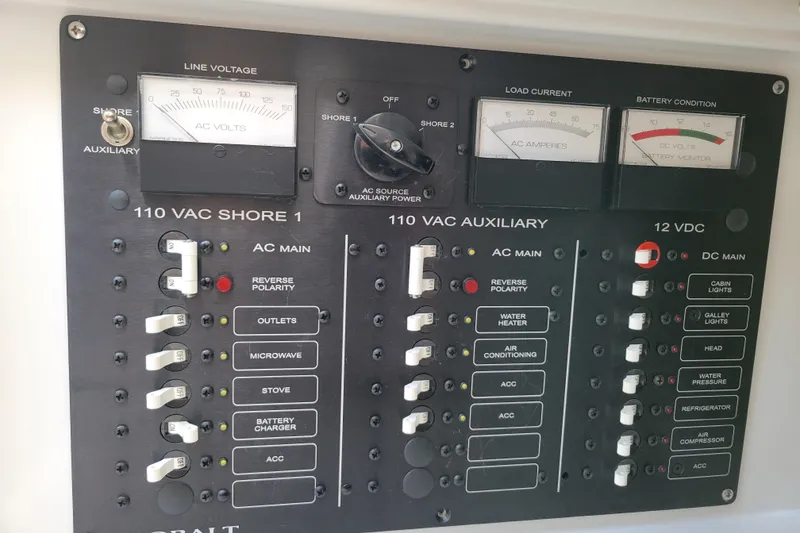 Slide: The Image of Electrical control panel on a 2002 Cobalt 293 boat, featuring voltage and current meters. - 26