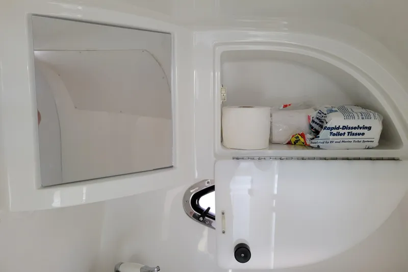 Slide: The Image of Cabinet interior of 2002 Cobalt 293 boat with mirror and toilet supplies. - 30