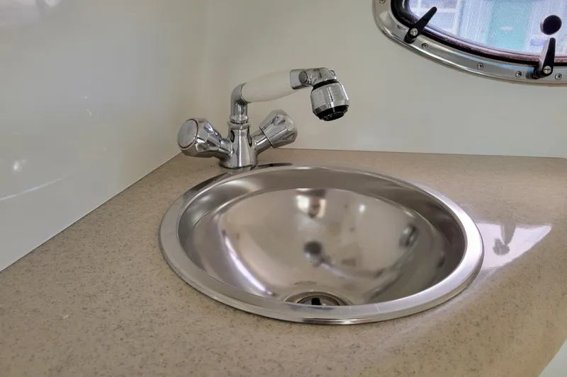 Slide: The Image of Stainless steel sink and faucet in 2002 Cobalt 293 boat interior. - 33