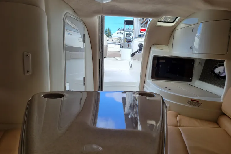 Slide: The Image of Interior view of a 2002 Cobalt 293 boat cabin with seating and storage. - 34