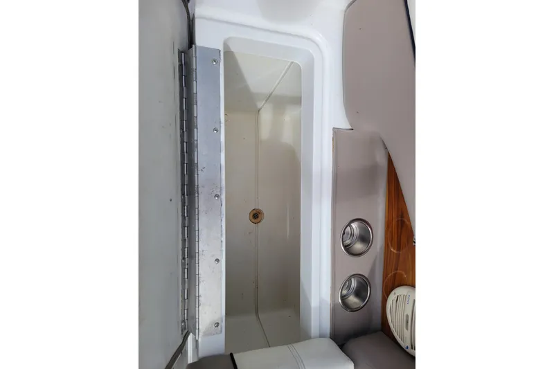 Slide: The Image of Interior storage compartment of a 2002 Cobalt 293 boat with cup holders. - 36