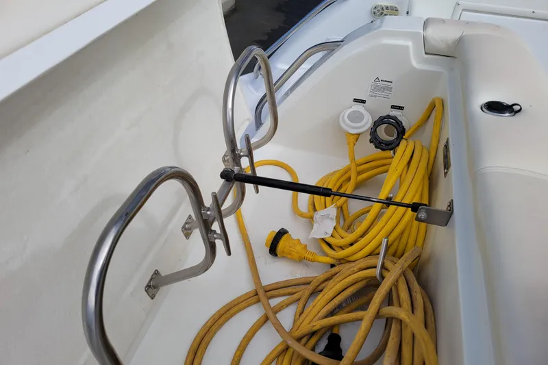Slide: The Image of 2002 Cobalt 293 boat interior with yellow power cords and stainless steel fittings. - 40