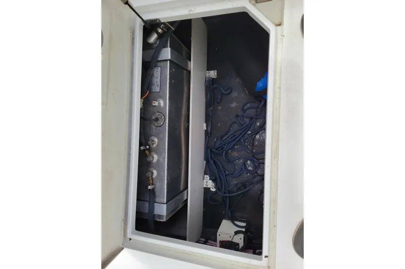 Slide: The Image of Open storage compartment in 2002 Cobalt 293 boat with ropes and equipment. - 41