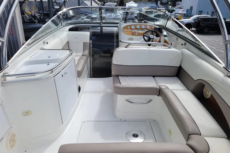 Slide: The Image of Interior of a 2002 Cobalt 293 boat featuring seating and control panel. - 6