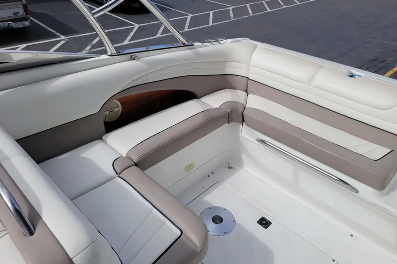 Slide: The Image of Interior seating of a 2002 Cobalt 293 boat, featuring white and beige upholstery. - 7
