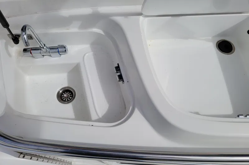 Slide: The Image of 2002 Cobalt 293 boat sink and faucet detail, featuring a clean white basin. - 9