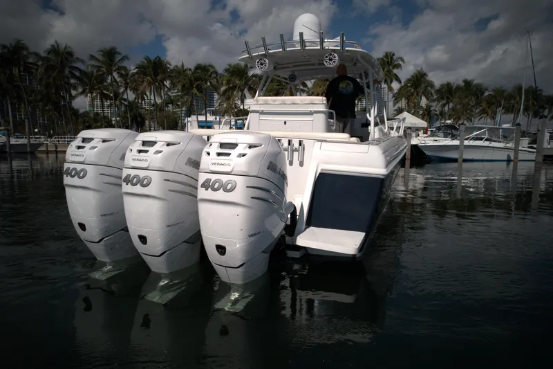 Slide: The Image of 2002 Intrepid 377 Walkaround Cuddy with triple 400 horsepower engines docked in marina. - 15