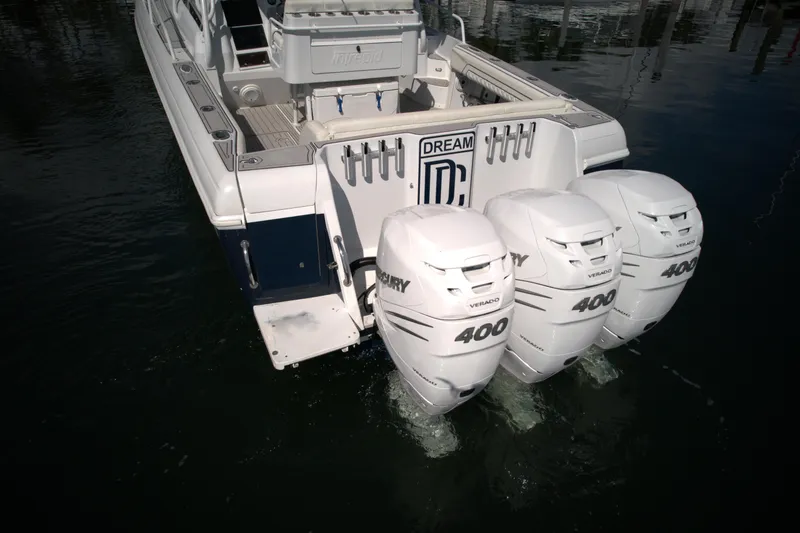 Slide: The Image of 2002 Intrepid 377 Walkaround Cuddy with triple Mercury 400 outboard engines. - 19