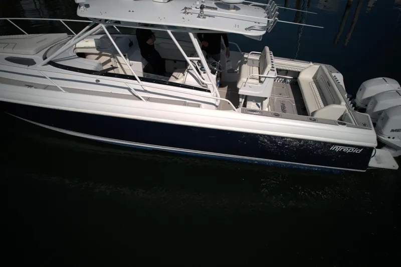Slide: The Image of 2002 Intrepid 377 Walkaround Cuddy boat on water, side view. - 21