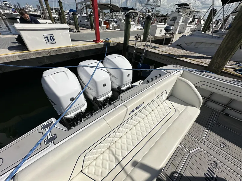 Slide: The Image of 2002 Intrepid 377 Walkaround Cuddy at dock with triple outboard engines. - 28