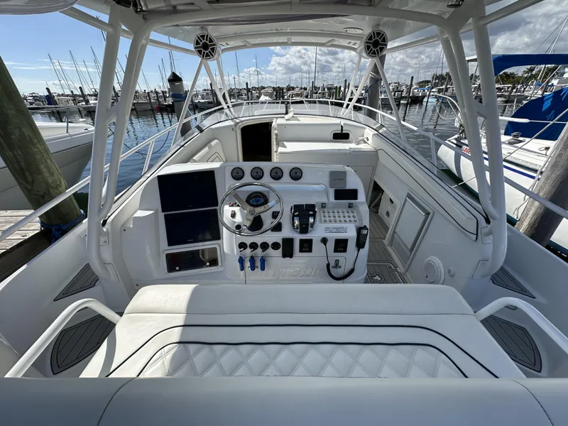 Slide: The Image of 2002 Intrepid 377 Walkaround Cuddy boat cockpit with steering wheel and control panel. - 30