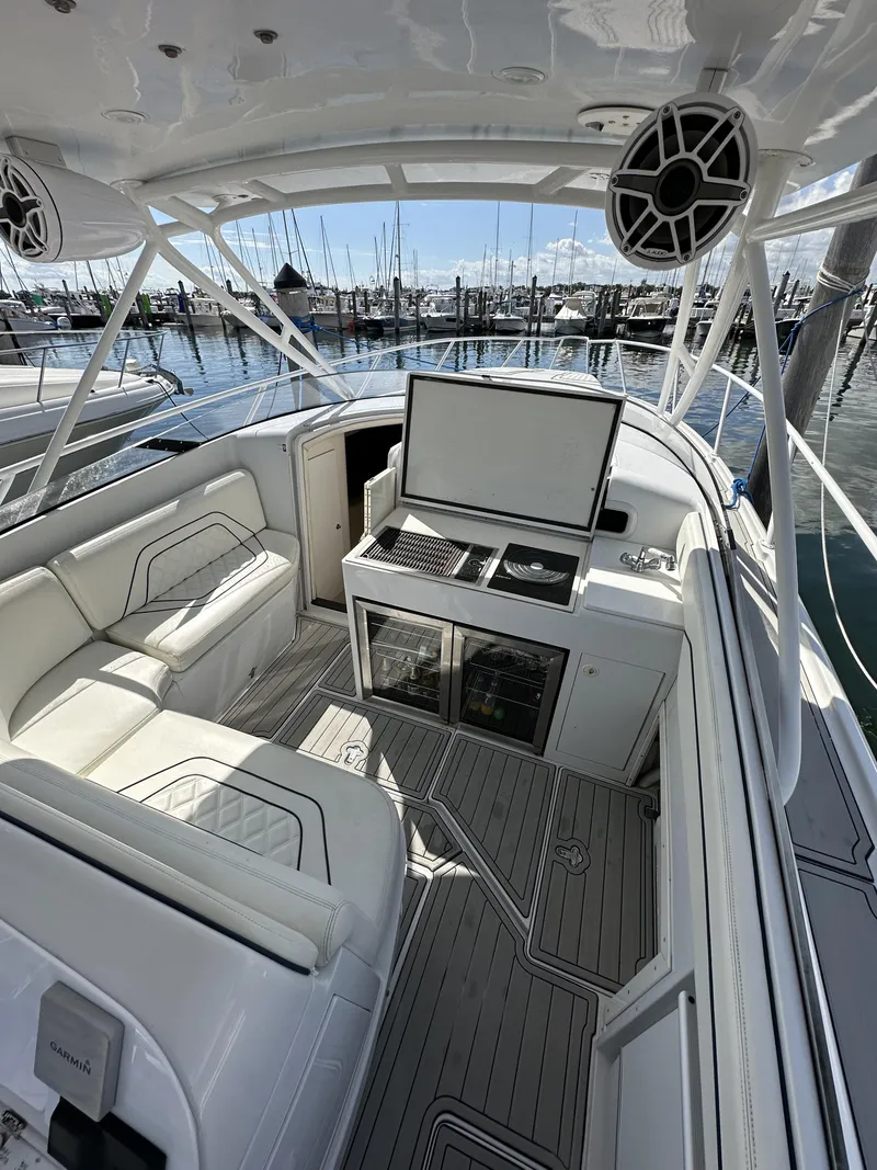 Slide: The Image of 2002 Intrepid 377 Walkaround Cuddy boat interior with seating and helm station. - 35