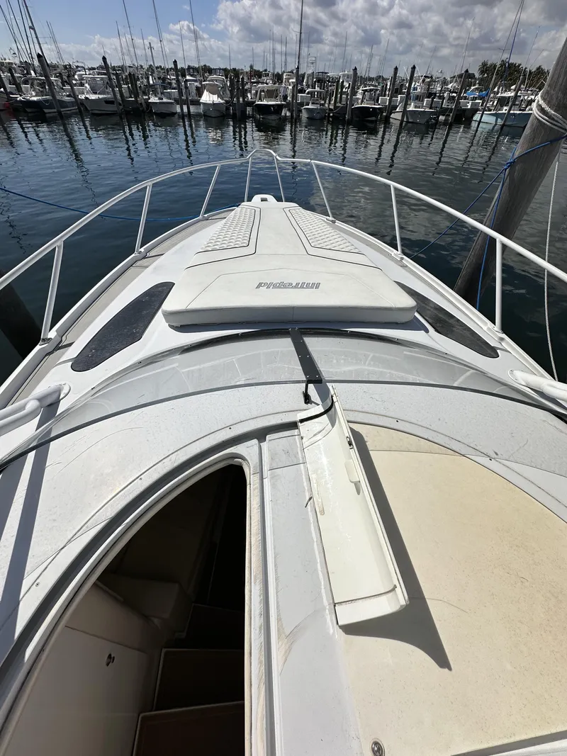 Slide: The Image of 2002 Intrepid 377 Walkaround Cuddy boat docked at a marina. - 36