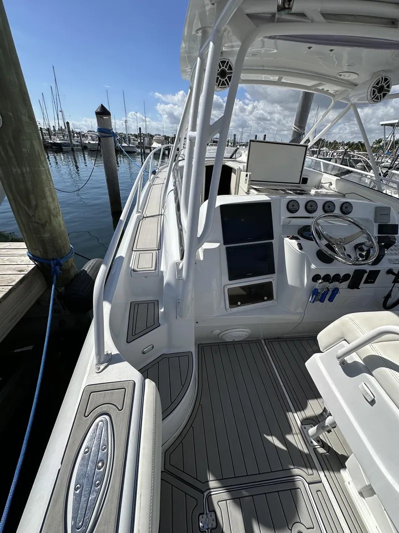 Slide: The Image of 2002 Intrepid 377 Walkaround Cuddy boat docked at marina. - 46