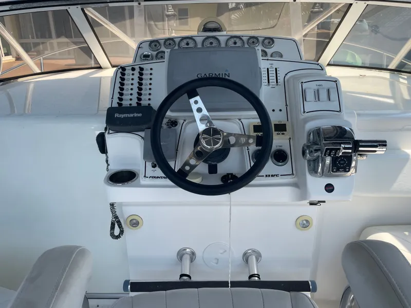 Slide: The Image of Helm console of a 2006 Fountain 33 Sport Fisherman boat. - 32