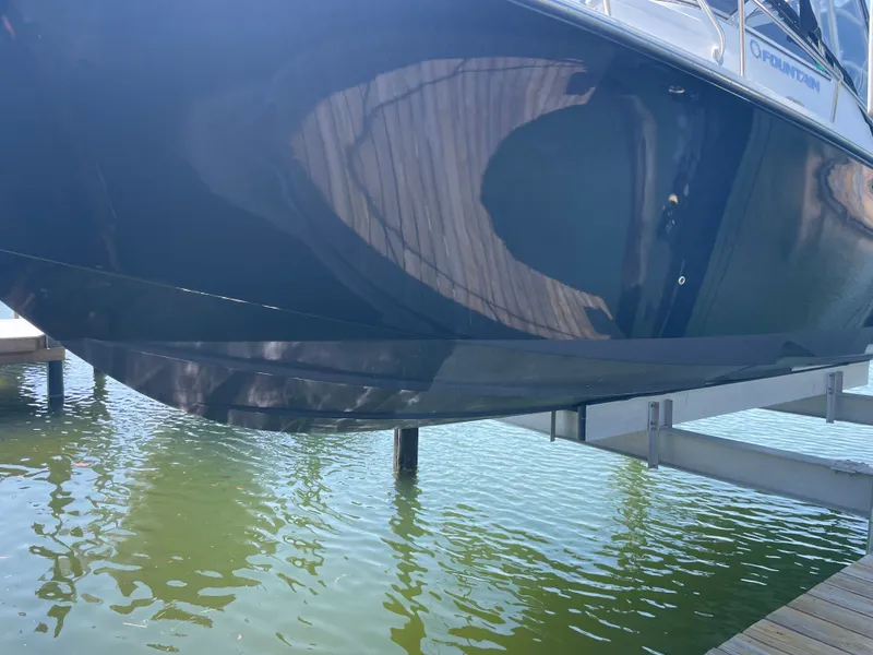 Slide: The Image of 2006 Fountain 33 Sport Fisherman on boat lift above water. - 4