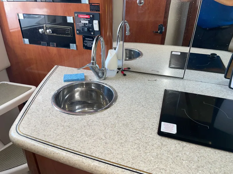 Slide: The Image of Interior of 2006 Fountain 33 Sport Fisherman with sink and stove. - 48