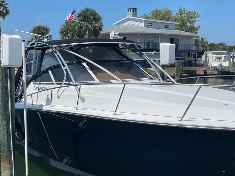 Slide: The Image of 2006 Fountain 33 Sport Fisherman boat docked with house in background. - 8