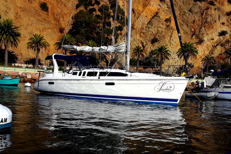 The Image of 1998 Hunter 34 sailboat docked with palm trees in the background. - 0