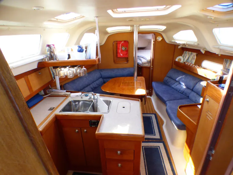 Slide: The Image of Interior of a 1998 Hunter 34 yacht with kitchen and seating area. - 20