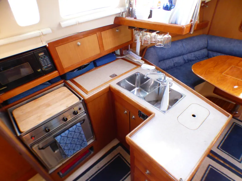 Slide: The Image of Interior of a 1998 Hunter 34 yacht with kitchen and seating area. - 21