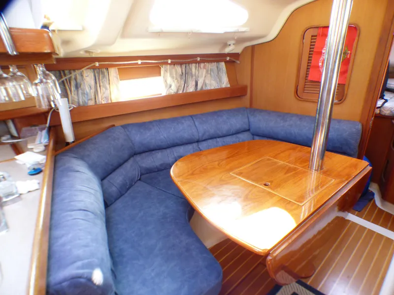 Slide: The Image of Interior of a 1998 Hunter 34 yacht with blue upholstery. - 23