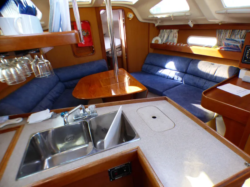 Slide: The Image of Interior of a 1998 Hunter 34 yacht with kitchen and seating area. - 26