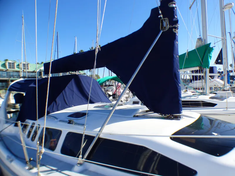 Slide: The Image of 1998 Hunter 34 sailboat docked with blue covers. - 4