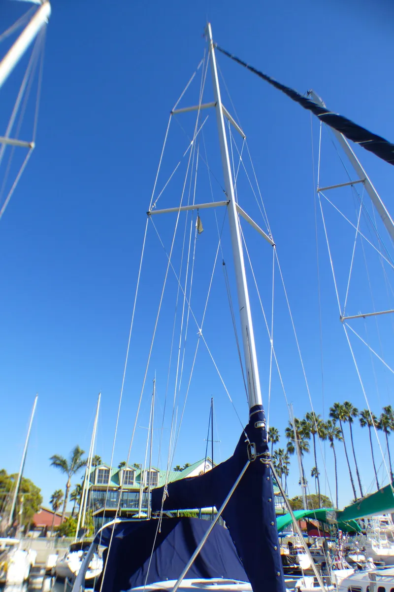 Slide: The Image of 1998 Hunter 34 sailboat in harbor, clear blue sky. - 41