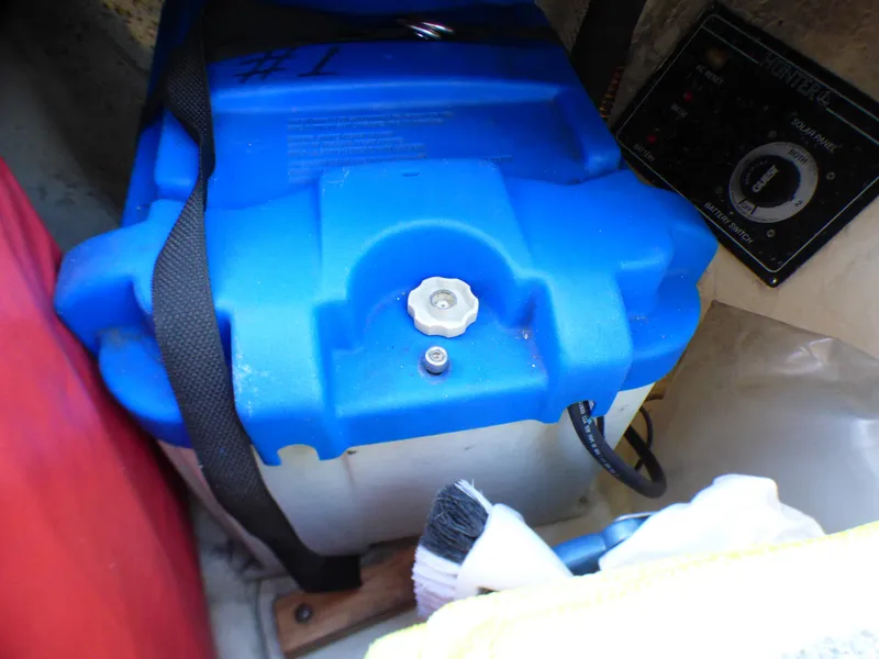 Slide: The Image of Battery in a 1998 Hunter 34 boat, blue casing, secured with strap. - 49