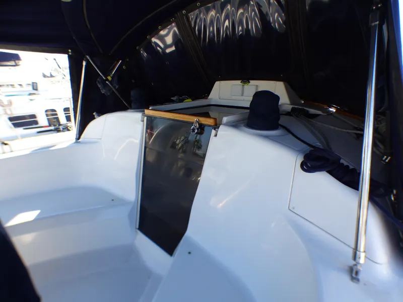 Slide: The Image of Interior of a 1998 Hunter 34 yacht, featuring a white cockpit. - 6