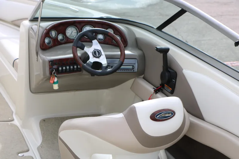 Slide: The Image of Interior of a 2006 Caravelle 207 Bow Rider boat, featuring steering wheel and dashboard controls. - 14