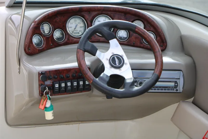 Slide: The Image of Dashboard of a 2006 Caravelle 207 Bow Rider boat with steering wheel and gauges. - 15