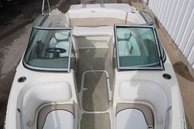 Slide: The Image of 2006 Caravelle 207 Bow Rider boat interior with open windshield and seating. - 16