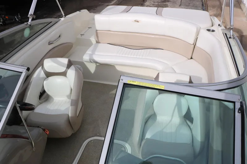 Slide: The Image of 2006 Caravelle 207 Bow Rider interior with white and beige seating. - 18