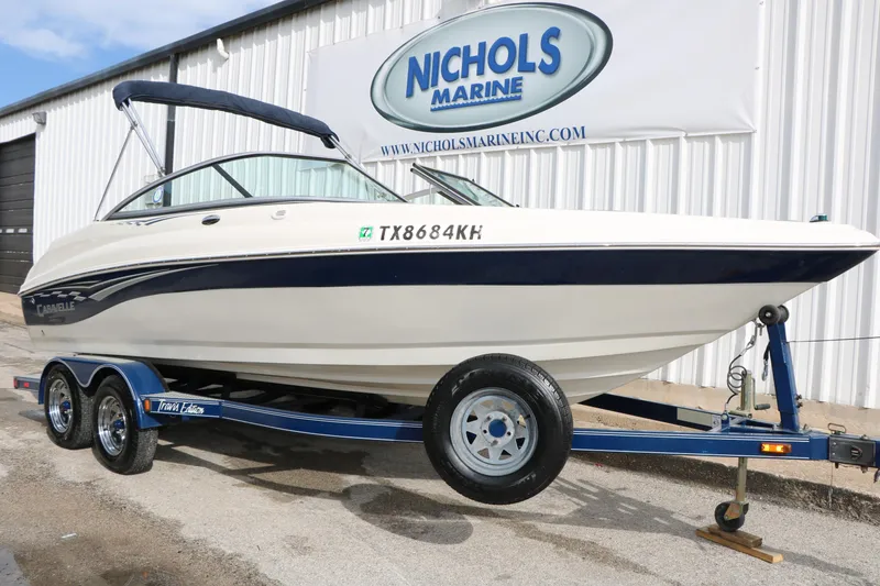 Slide: The Image of 2006 Caravelle 207 Bow Rider boat on trailer at Nichols Marine dealership. - 2