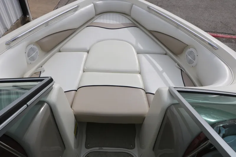 Slide: The Image of 2006 Caravelle 207 Bow Rider interior with cushioned seating and built-in speakers. - 21