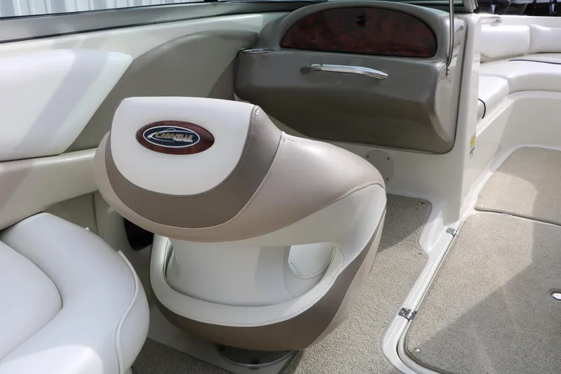 Slide: The Image of 2006 Caravelle 207 Bow Rider interior with beige and white seating. - 25