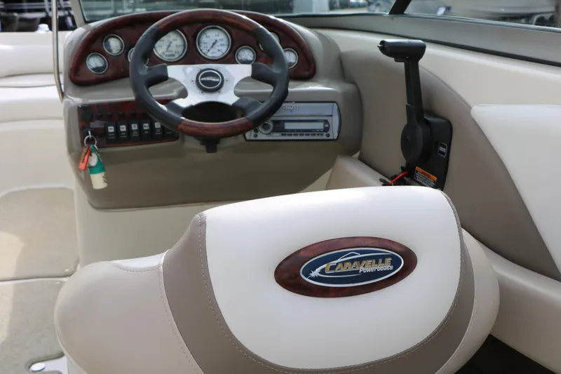 Slide: The Image of Interior of a 2006 Caravelle 207 Bow Rider boat, featuring steering wheel and dashboard. - 26